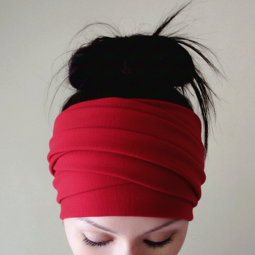 Person wearing a red headband against a plain background